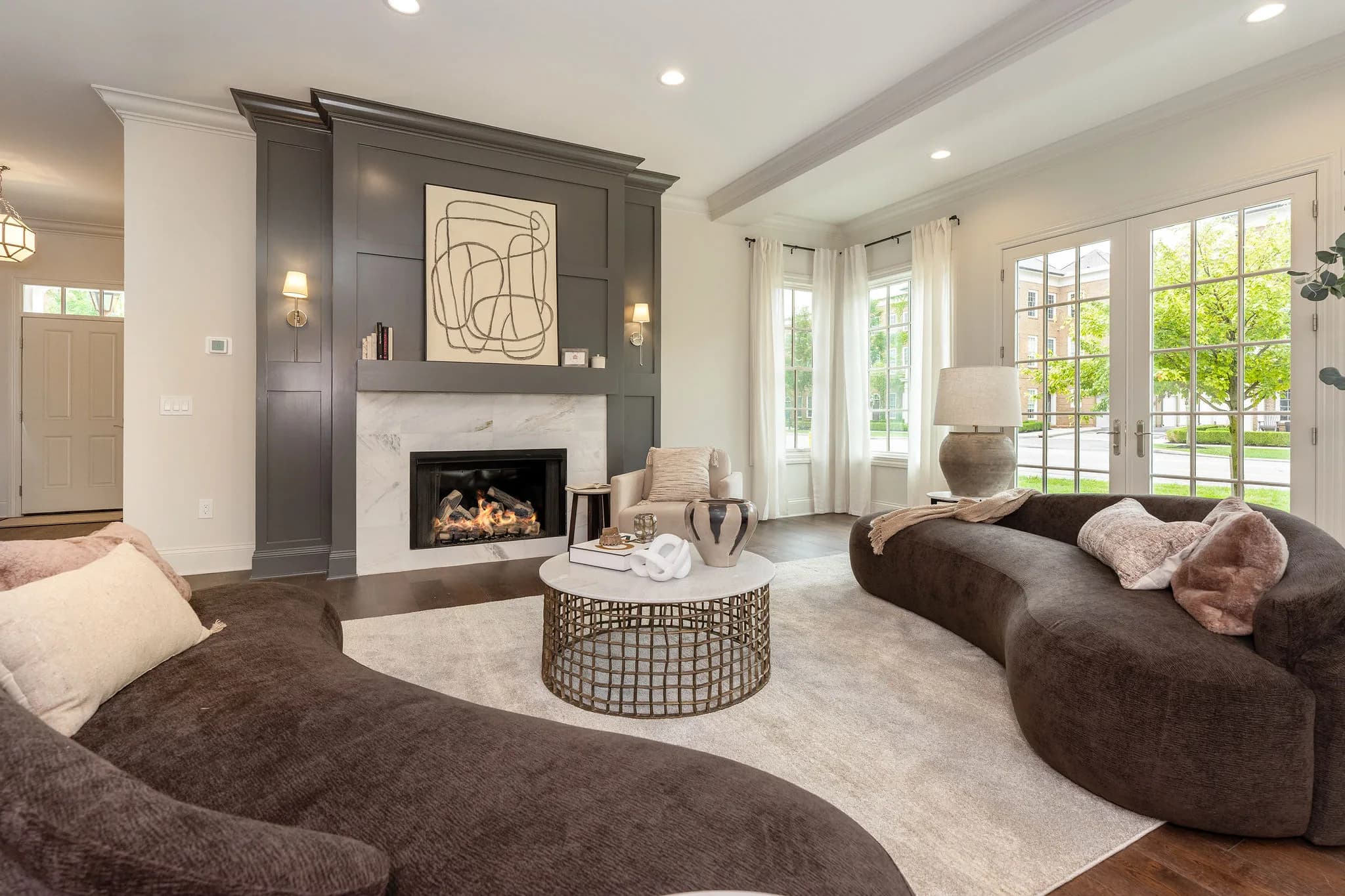 The great room of 115 Keswick — fireplace in a charcoal millwork surround